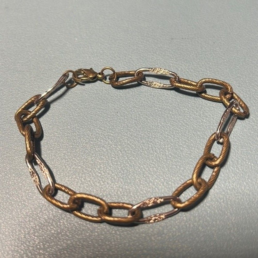Handcrafted antique gold and silver tone link bracelet.